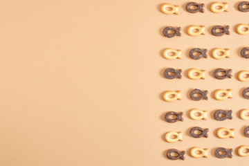 pattern of cookies in the shape of a fish on a beige background