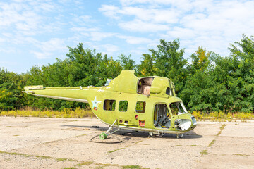 An old defective and looted helicopter is located on the territory of the field airfield. Soviet military aviation.