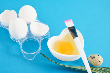 chicken egg shells, quail eggs, a heart-shaped bowl with a raw egg for making a face and hair mask