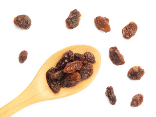 Raisin in spoon and bunch isolated on white. Macro. Healthy food concept