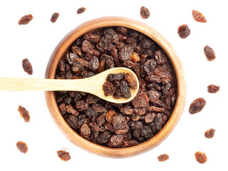 Raisin in wooden bowl and spoon, bunch isolated on white. Macro. Vegetarian concept