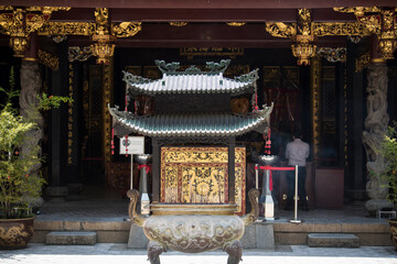 Singapore, Singapore - September 21, 2022: The Thian Hock Keng Temple in Singapore, dedicated to both Buddhism and Taoism, contrasts with the modern towers of the business district.