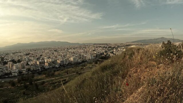 Time lapse video, shot from a hill shows a view of north suburbs of Athens city. High angle view with blue sky and clouds passing by. Unedited video.