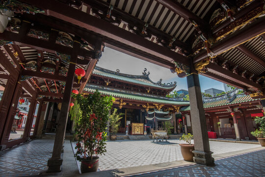Singapore, Singapore - September 21, 2022: The Thian Hock Keng Temple in Singapore, dedicated to both Buddhism and Taoism, contrasts with the modern towers of the business district.