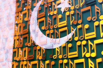 Musical notes lined up in even rows against the backdrop of the National Flag of  Pakistan.. The concept of the national anthem, music. 3D illustration