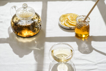 tea in a teapot and a glass nearby