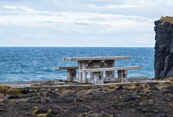 View during auto trip in West Iceland, Snaefellsnes peninsula, Skardsvik Beach. Spectacular black volcanic rocky ocean coast.