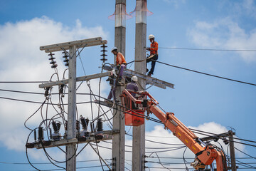 Electricians is repairing high voltage wires on electric power pole