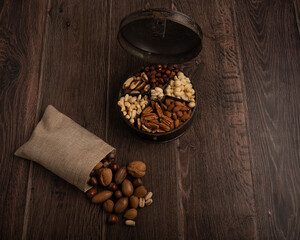 Festive mixed nuts on a dark wood background with copy space