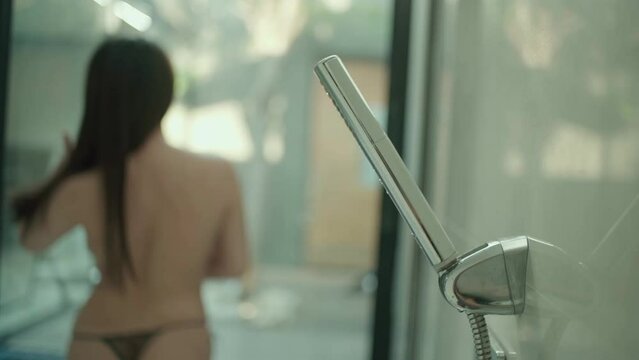 half naked asian female back side blur in the shower