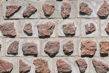 texture of masonry of red granite, natural stone and concrete rows