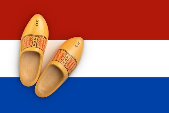 Wooden shoes flatlay on the colors of the dutch flag, as a concept for the dutch culture