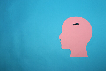 pink paper head with key in head, key for solving problems