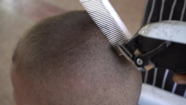Hairdresser cutting schoolchildren&rsquo;s hair to prepare for school day, rural or urban lifestyle.