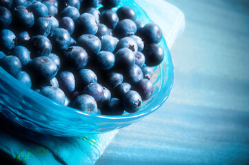 close-up to a bowl  of bluberries over blue background like summer fruit concept