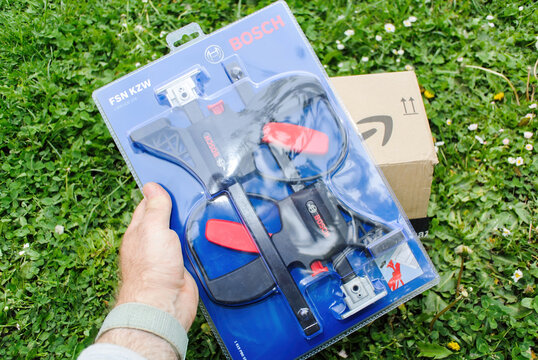Paris, France - Apr 29, 2022: POV male hand holding new unopened Bosch FSN Guide Rail Accessories