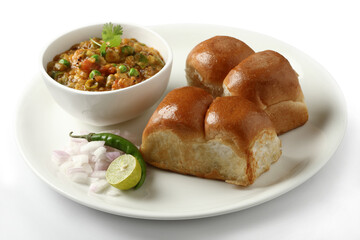 Pav Bhaji is a fast food dish from India, Thick and spicy vegetable curry, fried and served with a soft bread roll,Bun, Paav and butter. selective focus