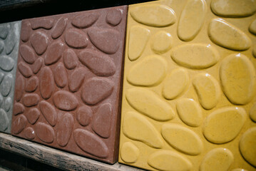 Paving slabs of different colors and shapes.Decorative cobblestones are different in color and shape.