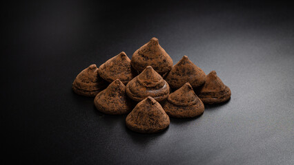 Chocolate truffles on a black background.