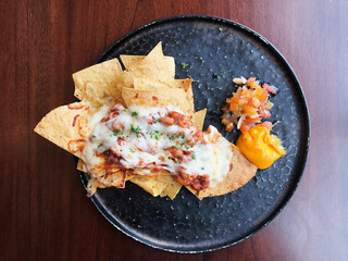 Top view of Nachos food with cheese and salsa sauce