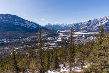 Overlooking the Town of Banff from Tunnel Mountain Trail summit in winter day. Banff National Park, Canadian Rockies, Alberta, Canada.