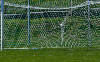 Fototapeta The ball in the goal during a league match. obraz