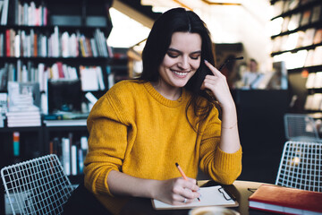 Smiling female taking notes on clipboard
