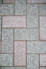 Texture of different colored patterned paving slabs . Modern road surface.