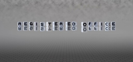 registered office word or concept represented by black and white letter cubes on a grey horizon background stretching to infinity