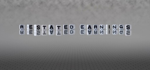 restated earnings word or concept represented by black and white letter cubes on a grey horizon background stretching to infinity - obrazy, fototapety, plakaty