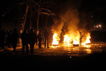 Night view of city street, tyres burning and protesters walking around. Revolution of dignity, Grushevskogo street