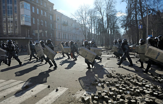 Policemen Berkut unit attacking protesters on Institutskaya street. Revolution of Dignity, the first street clashes. Kiev, Ukraine