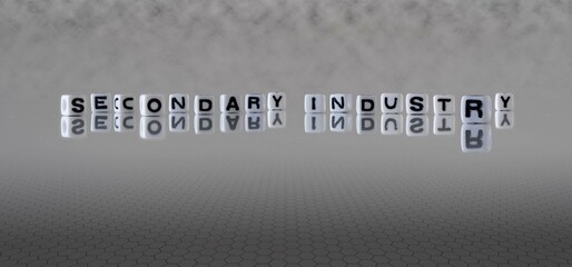 secondary industry word or concept represented by black and white letter cubes on a grey horizon...