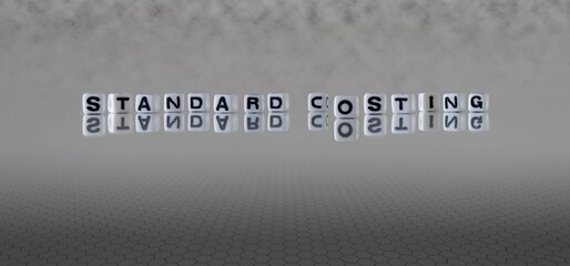 standard costing word or concept represented by black and white letter cubes on a grey horizon...