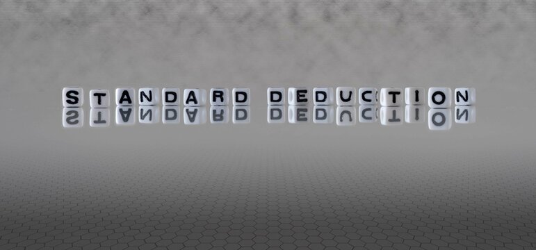 Standard Deduction Word Or Concept Represented By Black And White Letter Cubes On A Grey Horizon Background Stretching To Infinity