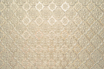 Textured pale beige light faded background with a pattern, painted glass in vintage style wall
