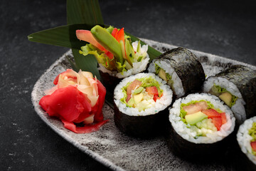 Sushi roll Yasai on a dark plate