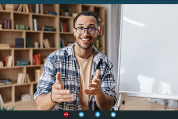 Virtual tutoring concept. Arab male teacher having video call, teaching foreign languages remotely...