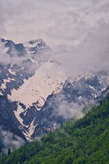 Dramatic fog over forest and dark mood in the snow covered mountains - Königssee Alps