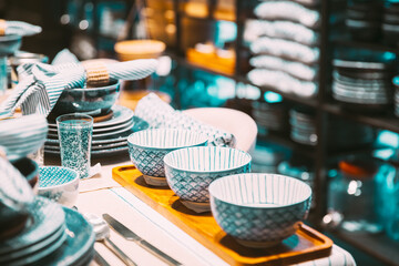 View of assortment of decor for interior shop in store of shopping center. Home accessories and household products for dining room in store of shopping centre. View of beautiful dinnerware on table