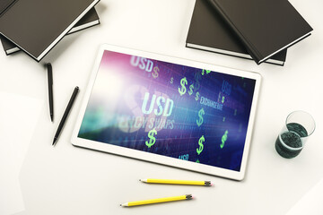 Top view of modern digital tablet monitor with creative USD symbols hologram. Banking and investing concept. 3D Rendering