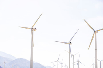 Wind turbines turning with the wind in the middle of a clear sky