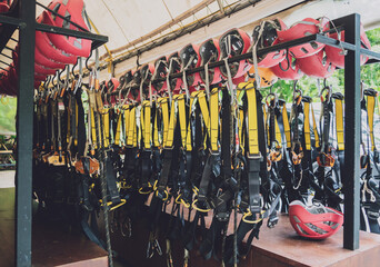 Rows of climbing safety ropes and carabiners and helmets