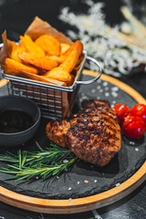 beef steak with potato, tomatoes and rosemary