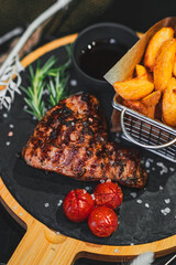 beef steak with potato, tomatoes and rosemary