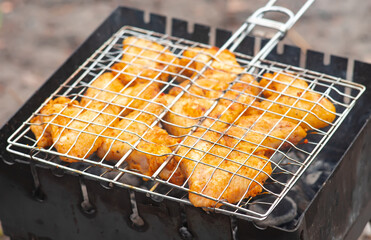 Grilled bird meat on grill. Wings of chicken, turkey, duck, quail, pigeon. Popular restaurant recipes for dietary cuisine. Family dinner and rest, picnic, barbecue, grill. Festive bird dinner.