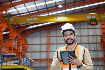 Selective focus at Asian men engineer supervisor, wearing safety equipment. While using digital...