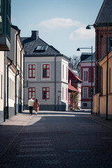 Young student couple walking down the cobblestoned street in Lund old town in Sweden