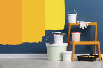 Set with decorator tools and paint on floor near color wall © New Africa