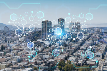 Panoramic cityscape view of San Francisco financial downtown at day time from rooftop, California, United States. Decentralized economy. Blockchain, cryptography and cryptocurrency concept, hologram